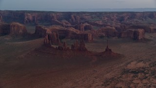 AX134_036 - 5.5K aerial stock footage of buttes and rock formations in Monument Valley, Utah, Arizona, twilight