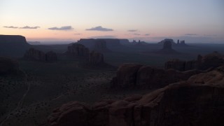 AX134_039 - 5.5K stock footage aerial video of a wide view of desert buttes and mesas in Monument Valley, Utah, Arizona, twilight