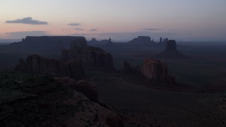 AX134_041 - 5.5K stock footage aerial video of desert buttes and mesas in famous Monument Valley, Utah, Arizona, twilight