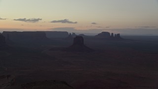 AX134_052 - 5.5K aerial stock footage of flying by East Mitten Butte, mesas, and buttes in Monument Valley, Utah, Arizona, twilight