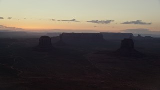 AX134_053E - 5.5K aerial stock footage of Merrick Butte, East Mitten Butte in Monument Valley, Utah, Arizona, twilight