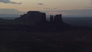 AX134_059E - 5.5K aerial stock footage of buttes in a layer of haze, Monument Valley, Utah, Arizona, twilight