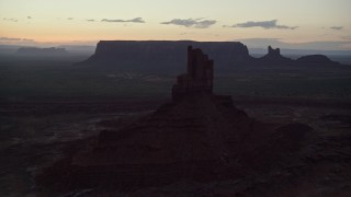 AX134_062E - 5.5K aerial stock footage of flying by Big Indian Butte in Monument Valley, Utah, Arizona, twilight
