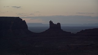 AX134_064 - 5.5K aerial stock footage of Setting Hen Butte in Monument Valley, Utah, Arizona, twilight