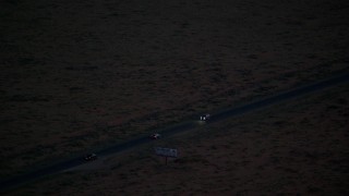 AX134_069 - 5.5K stock footage aerial video track SUV on highway in desert, Monument Valley, Utah, Arizona, twilight