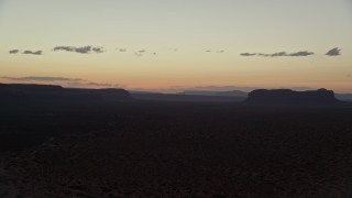 AX134_072 - 5.5K aerial stock footage of flying by Oljeto Mesa and Train Rock at Navajo Nation Reservation, Arizona, Utah, twilight