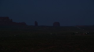 AX134_074 - 5.5K stock footage aerial video of West Mitten Butte, Merrick Butte in Monument Valley, Utah, night