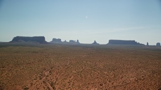 AX135_001E - 5.5K aerial stock footage of flying by mesas and buttes across desert, Monument Valley, Utah, Arizona