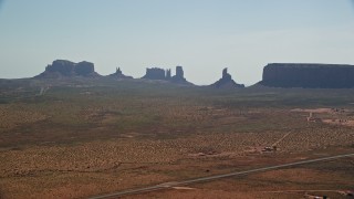AX135_004 - 5.5K aerial stock footage of flying by desert buttes and mesas in Monument Valley, Utah, Arizona