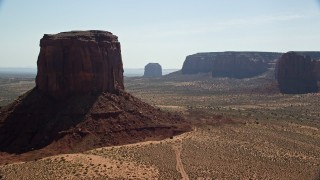 AX135_008E - 5.5K aerial stock footage of passing Mitchell Butte and Merrick Butte, reveal other buttes in Monument Valley, Utah, Arizona
