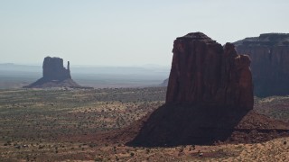 AX135_010E - 5.5K aerial stock footage of flying by buttes, mesas, and The View Hotel, Monument Valley, Utah, Arizona