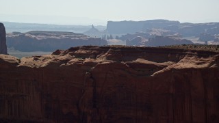 AX135_012E - 5.5K aerial stock footage fly over Mitchell Mesa, and approach mesas, buttes in Monument Valley, Utah, Arizona