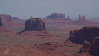 AX135_020 - 5.5K stock footage aerial video flying by Merrick Butte, Camel Butte, Elephant Butte in Monument Valley, Utah, Arizona