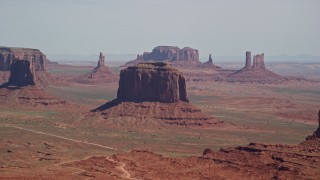 AX135_020E - 5.5K aerial stock footage flyby Merrick Butte, Camel Butte, Elephant Butte, with buttes and mesas in distance, Monument Valley, Utah, Arizona
