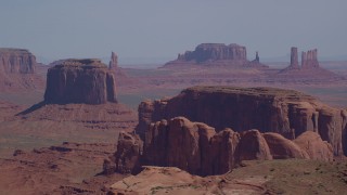 AX135_021 - 5.5K stock footage aerial video flyby Merrick Butte, Camel Butte, Elephant Butte, with buttes and mesas in distance, Monument Valley, Utah, Arizona