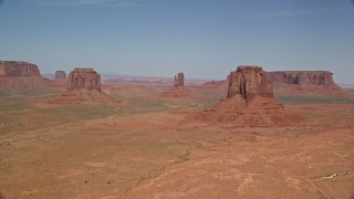AX135_036 - 5.5K aerial stock footage of slowly passing buttes in a desert valley, Monument Valley, Utah, Arizona