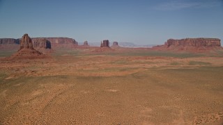 AX135_041E - 5.5K aerial stock footage of passing several desert buttes and mesas in Monument Valley, Utah, Arizona