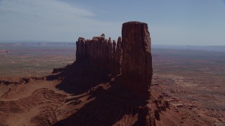 AX135_048 - 5.5K stock footage aerial video of flying by tall desert buttes in Monument Valley, Utah, Arizona