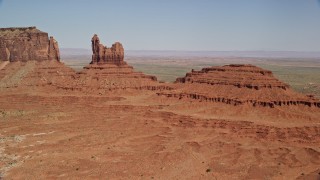 AX135_050 - 5.5K aerial stock footage of approaching Setting Hen Butte in Monument Valley, Utah, Arizona