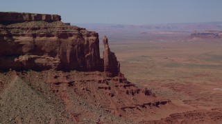 AX135_054 - 5.5K stock footage aerial video of flying away from Eagle Rock Butte by Eagle Mesa, Monument Valley, Utah, Arizona
