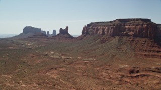 AX135_056E - 5.5K aerial stock footage approach Setting Hen Butte in Monument Valley, Utah, Arizona
