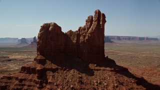AX135_061 - 5.5K aerial stock footage of flying by buttes and mesas in desert valley, Monument Valley, Utah, Arizona