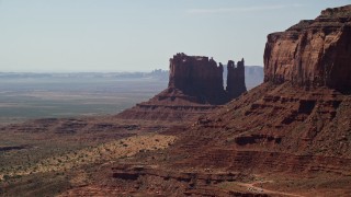 AX135_063E - 5.5K aerial stock footage of passing by desert buttes in Monument Valley, Utah, Arizona