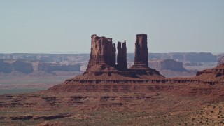 AX135_065 - 5.5K aerial stock footage of a group of desert buttes in Monument Valley, Utah, Arizona