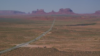 AX135_075 - 5.5K stock footage aerial video of approaching Forrest Gump Point and Highway 163, Monument Valley, Utah, Arizona