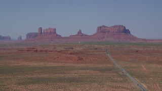 AX135_079 - 5.5K stock footage aerial video of a wide view of desert buttes, seen from Highway 163, Monument Valley, Utah, Arizona