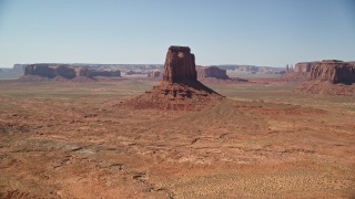 AX135_115E - 5.5K aerial stock footage approach and flyby East Mitten Butte, reveal Elephant Butte, Monument Valley, Utah, Arizona