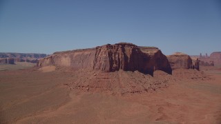 AX135_119 - 5.5K stock footage aerial video orbit Spearhead Mesa in a desert valley, Monument Valley, Utah, Arizona