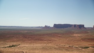 AX135_120 - 5.5K aerial stock footage of approaching Rooster Rock and Meridian Butte, Monument Valley, Utah, Arizona