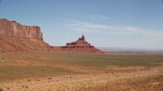 AX135_133 - 5.5K aerial stock footage descend and approach Rooster Rock, Monument Valley, Utah, Arizona