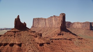 AX135_138 - 5.5K aerial stock footage of passing by Rooster Rock and Meridian Butte, Monument Valley, Utah, Arizona