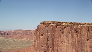 AX135_142E - 5.5K aerial stock footage of flying over Meridian Butte, revealing Rooster Rock, Monument Valley, Utah, Arizona