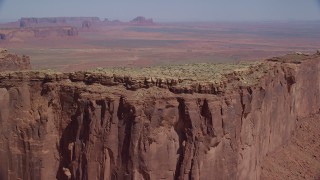 AX135_143 - 5.5K stock footage aerial video of flying by the top of Meridian Butte, Monument Valley, Utah, Arizona