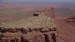 AX135_144 - 5.5K stock footage aerial video of flying over Meridian Butte, revealing Rooster Rock, Monument Valley, Utah, Arizona