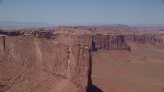 AX135_149 - 5.5K stock footage aerial video of approaching Meridian Butte in a desert valley, Monument Valley, Utah, Arizona