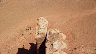 AX135_156 - 5.5K aerial stock footage of flying over Meridian Butte and tilt to bird's eye view, Monument Valley, Utah, Arizona