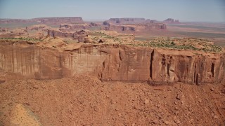 AX135_168E - 5.5K aerial stock footage of flying over the top of Meridian Butte in Monument Valley, Utah, Arizona