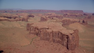 AX135_172 - 5.5K stock footage aerial video of approaching a desert mesa in Monument Valley, Utah, Arizona