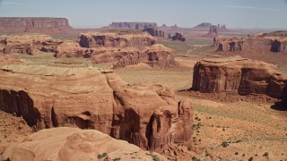 AX135_177E - 5.5K aerial stock footage of a wide view of numerous desert buttes and mesas, Monument Valley, Utah, Arizona