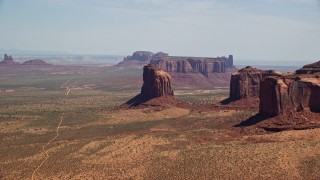 AX135_190E - 5.5K aerial stock footage of passing by Gray Whiskers Butte, Monument Valley, Arizona, Utah