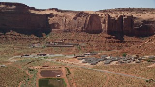 AX135_205 - 5.5K aerial stock footage of flying by Goulding's Lodge at the base of Rock Door Mesa, Goulding, Utah
