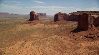 AX136_011 - 5.5K aerial stock footage of flying by Gray Whiskers Butte, Mitchell Mesa, Monument Valley, Utah, Arizona