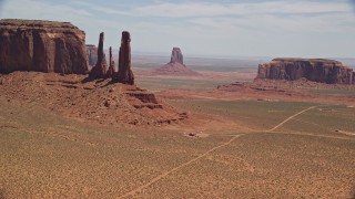 AX136_017E - 5.5K aerial stock footage of buttes in a desert valley, Monument Valley, Utah, Arizona