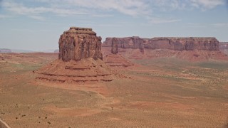 AX136_028E - 5.5K aerial stock footage of flying by Merrick Butte near West Mitten Butte, Monument Valley, Utah, Arizona