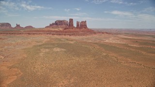 AX136_034E - 5.5K aerial stock footage of flying toward jagged desert buttes, Monument Valley, Utah, Arizona