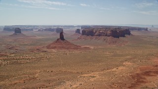 AX136_042 - 5.5K aerial stock footage of flying away from Big Indian Butte and Sentinel Mesa, Monument Valley, Utah, Arizona